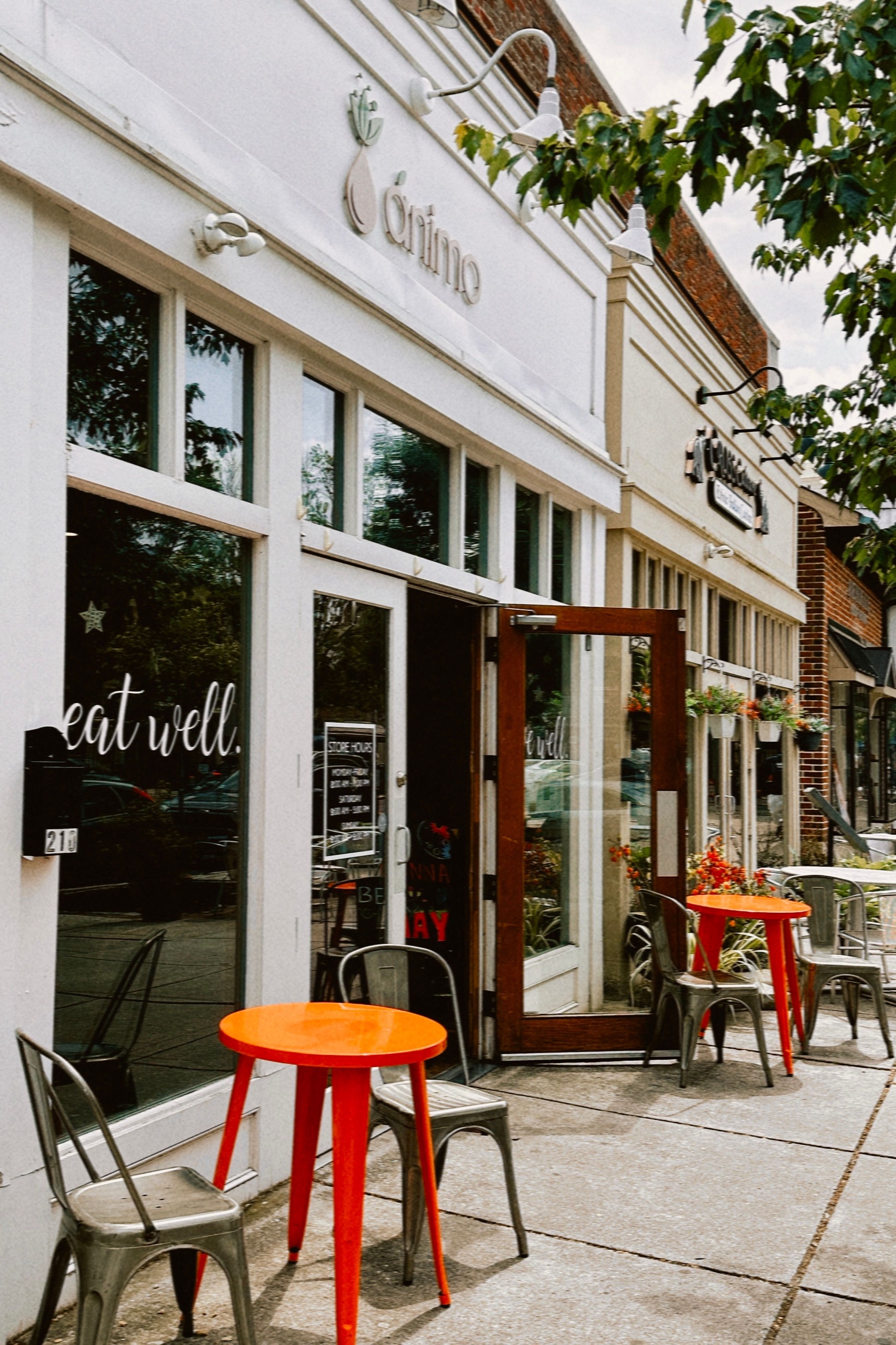 A local restaurant storefront with outdoor bistro tables